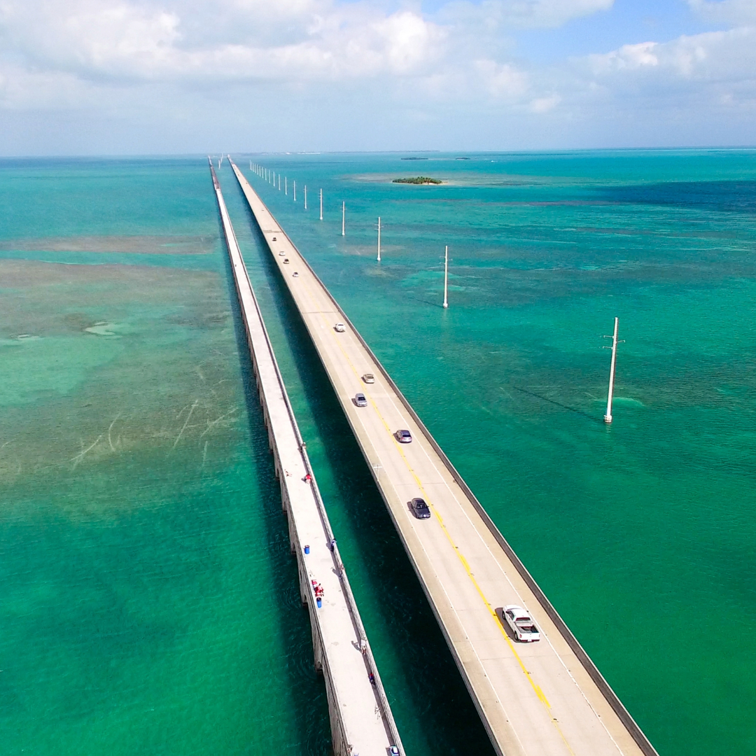 Aerial view of cars driving on bridges over turquoise water on a Florida Keys road trip